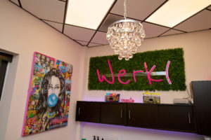 picture of their brand name "werk"neon sign above their cabinets