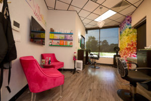 photo of other side of their suite featuring floor to ceiling windows and a wall covered in flowers.