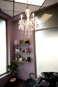MY SALON Suite Member Josh Trotter's suite with shelves and chandelier
