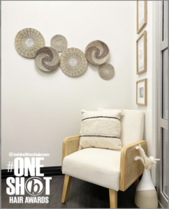 picture of a chair in the corner of the suite with woven decor on the walls.