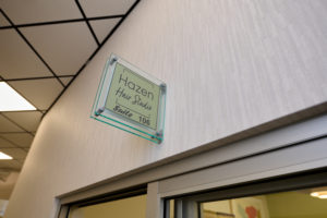 Amy's logo and wall sign out side of her suite.