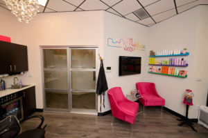 picture of their suite doors and a corner of their suite with pink chairs