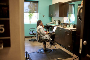 picture of a Member using their laptop in their suite.