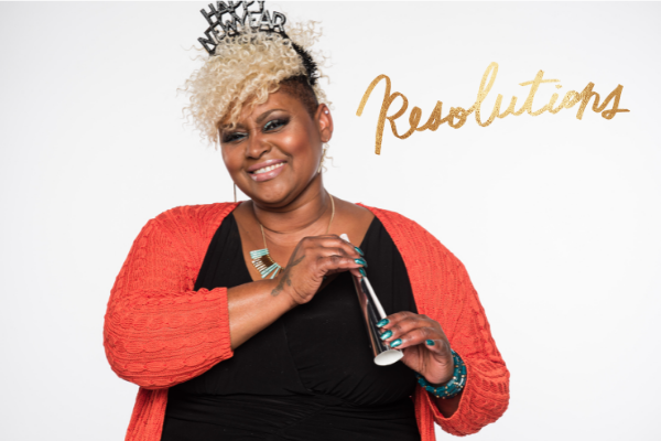 member smiling with new years party favors.