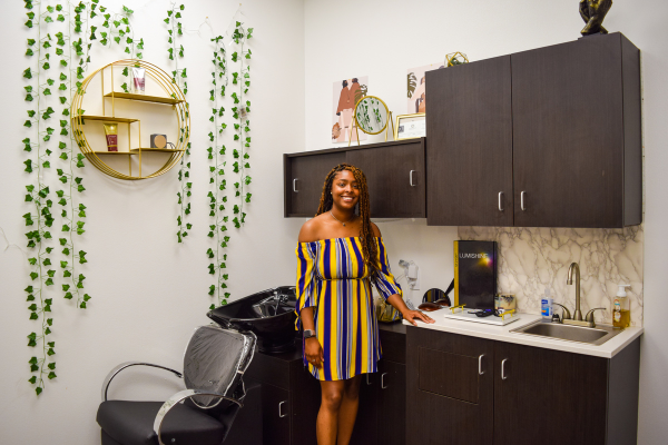 A suite elite member standing in her suite.