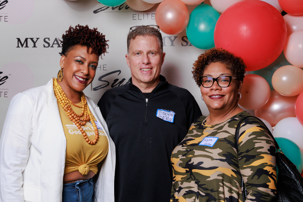 two Members and a franchisee with balloons