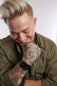 MY SALON Suite Member Josh Trotter posing with his tattoos