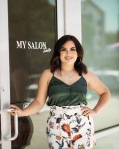 woman posing at my salon suite door