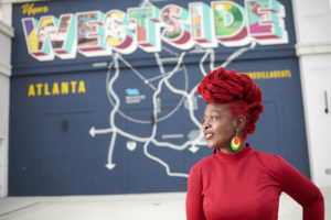 MY SALON Suite Member Latoya standing in front ofWestside, Atlanta mural