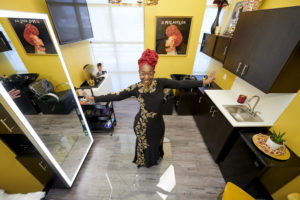 MY SALON Suite Member Latoya standing in her yellow suite