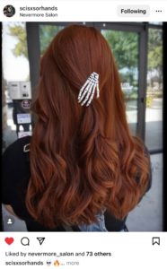picture of hair with a skeleton hand in it