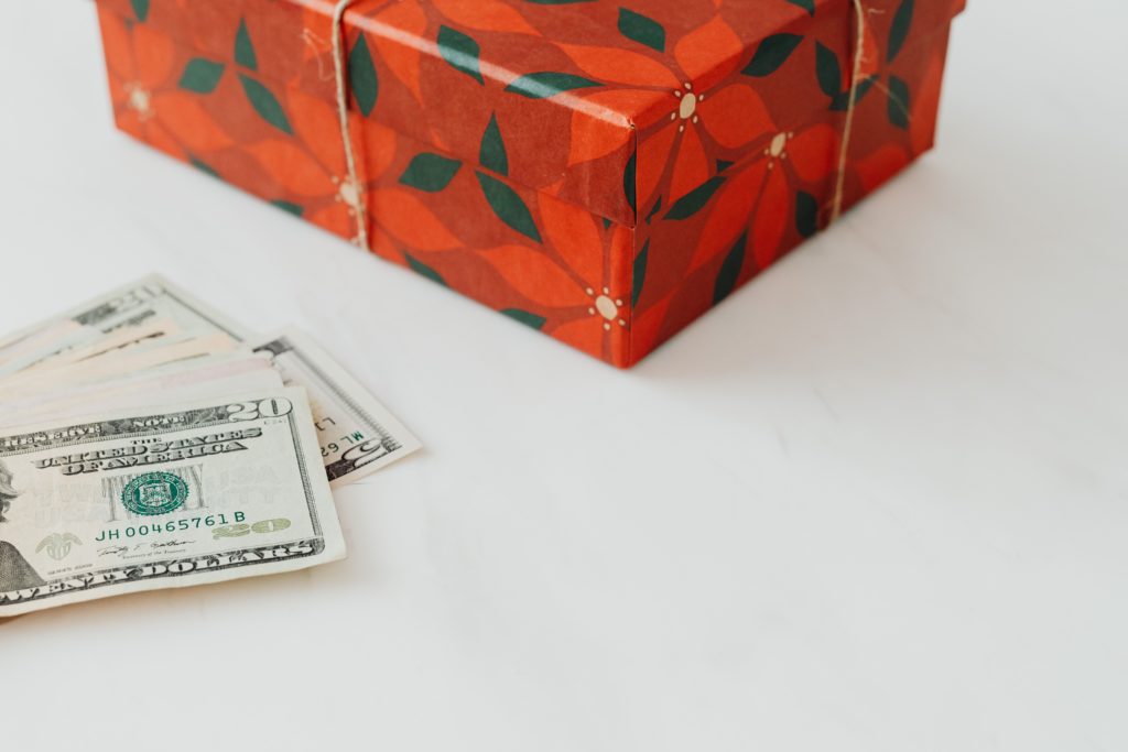 Picture of cash next to a wrapped present.