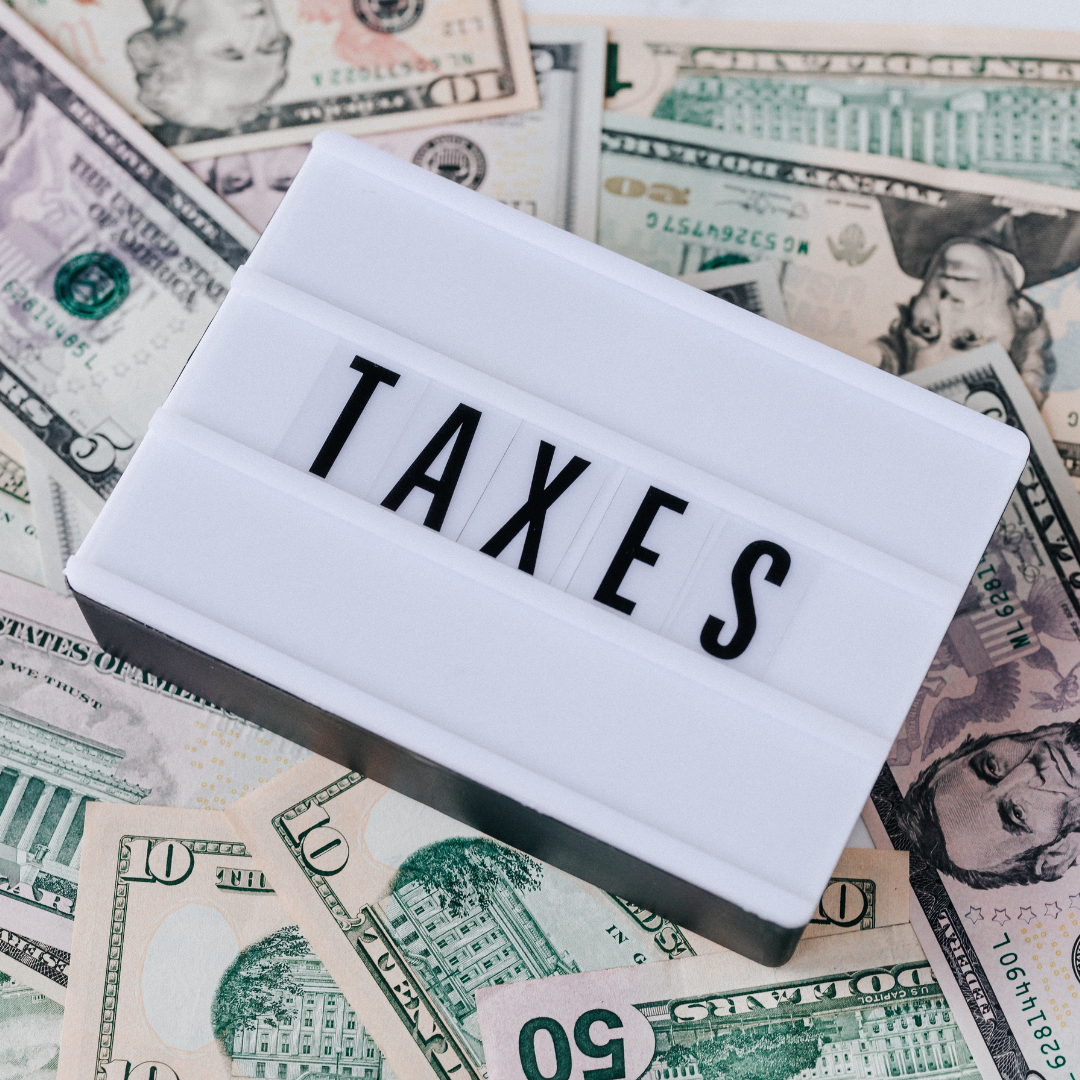 Sign that says taxes surrounded by money