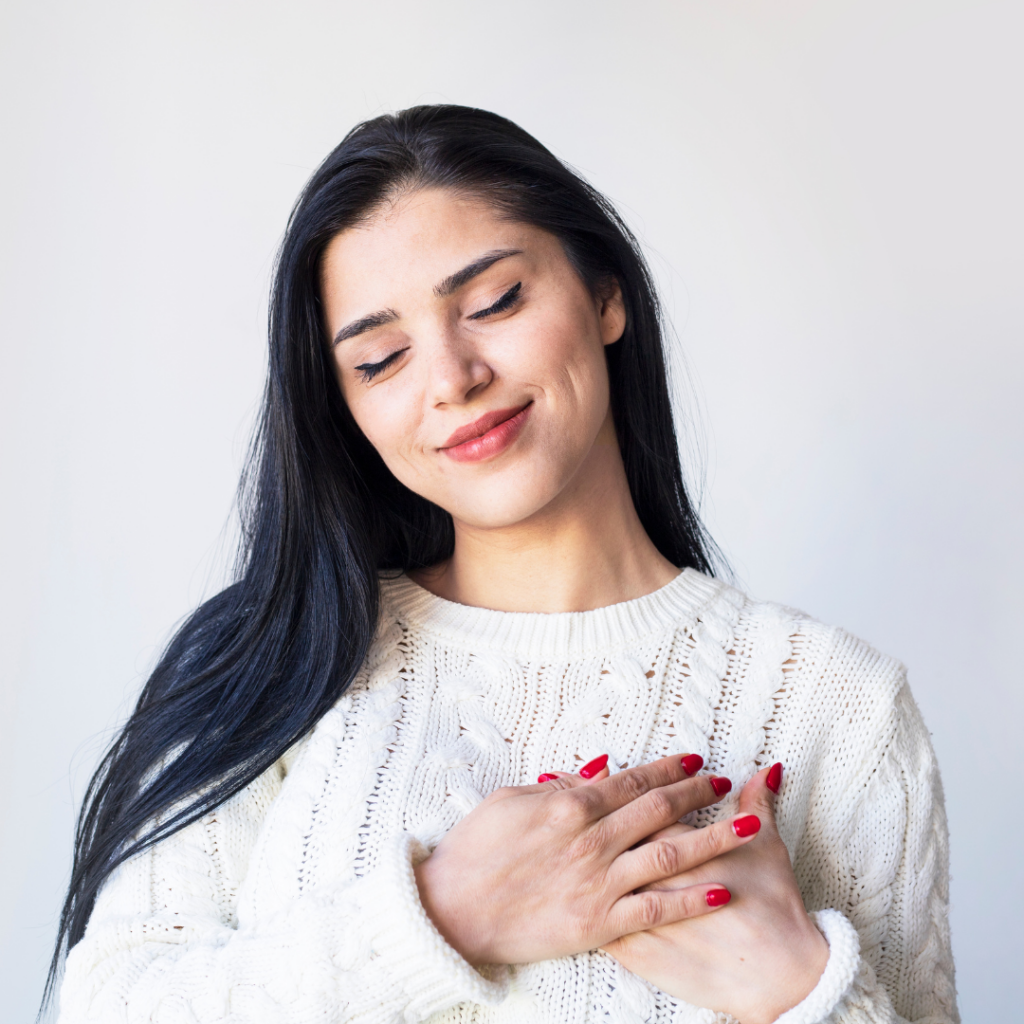 woman touching her heart