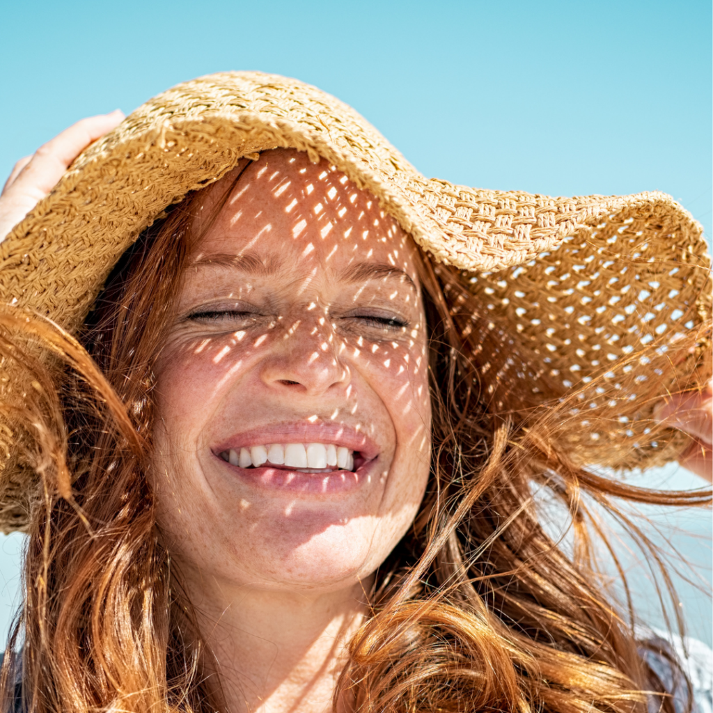 woman smiling in the sun.